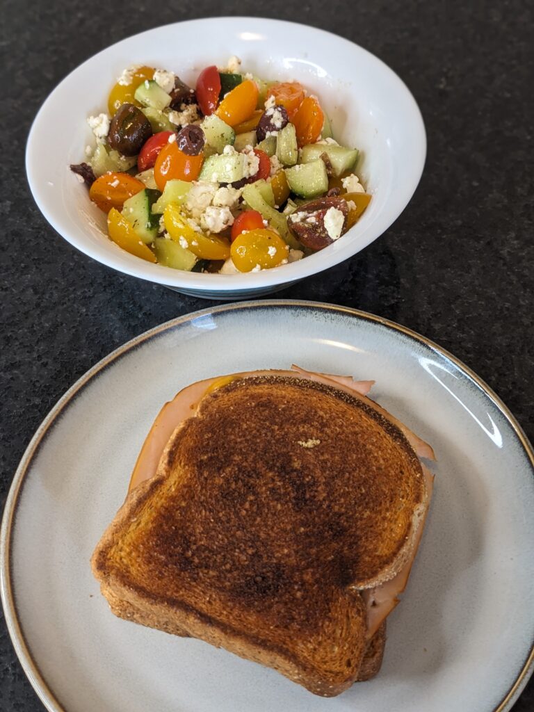 Greek Salad and grilled cheese and ham sandwich